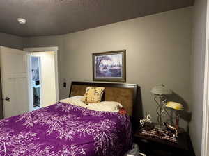 Bedroom featuring a textured ceiling