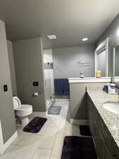 Full bathroom with a shower stall, vanity, and a textured ceiling