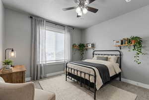 Bedroom with carpet flooring and a ceiling fan