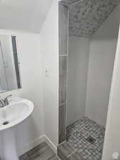 Full bathroom featuring a stall shower, a textured ceiling, and wood finished floors