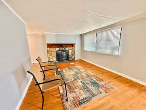 Living area with light wood-style floors and a fireplace