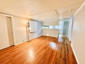 Unfurnished room with light wood-type flooring and a textured ceiling