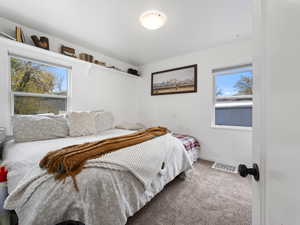 Bedroom featuring carpet floors and baseboards