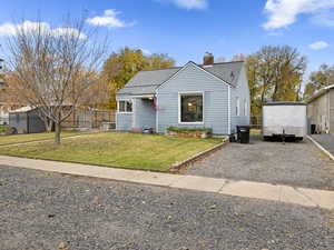Bungalow with roof with shingles and a chimney