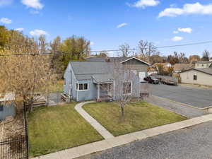 View of front of house with a shingled roof and driveway