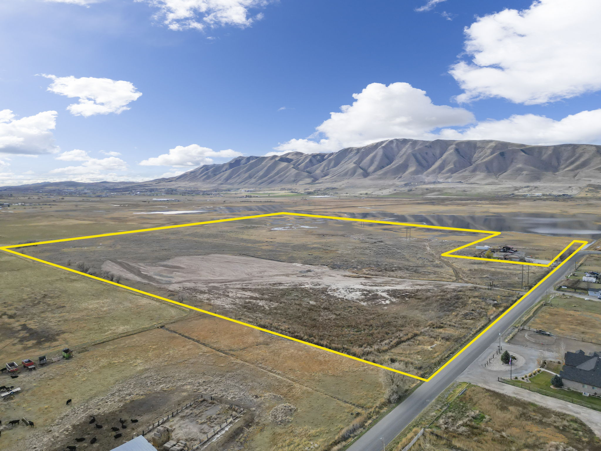 View of rural area with a mountainous background and property boundaries highlighted