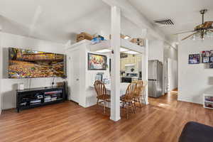 Dining area featuring light wood-type flooring and a ceiling fan