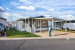 Manufactured / mobile home with a carport and covered porch