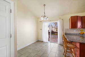 Dining space featuring lofted ceiling and a chandelier