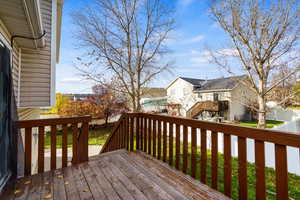 Wooden deck with a residential view and stairs