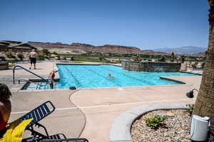 Community pool with a patio area and a mountain view