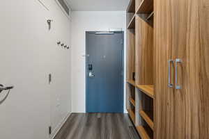 Doorway featuring wood finished floors and baseboards