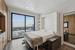 Bedroom featuring access to outside and dark wood-type flooring