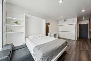 Bedroom featuring dark wood-style flooring and recessed lighting