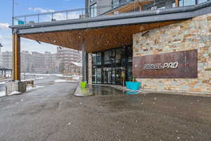 View of exterior entry featuring stone siding