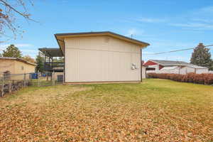 View of outdoor structure with a gate and a sunroom