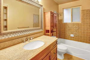 Full bath with washtub / shower combination and vanity