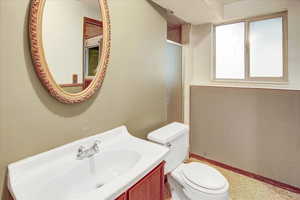 Bathroom with vanity and a shower with door