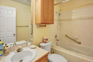 Bathroom with vanity and tiled shower / bath combo