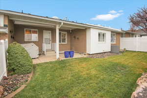 Rear view of house with a patio area and brick siding