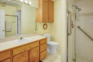 Bathroom with vanity, a shower stall, and light tile patterned floors