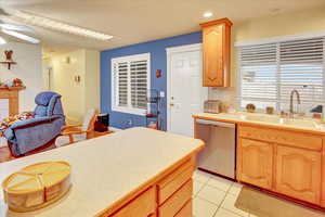 Kitchen featuring light countertops, dishwasher, light tile patterned flooring, recessed lighting, and a ceiling fan