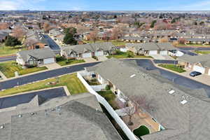 Aerial view of property and surrounding area with nearby suburban area