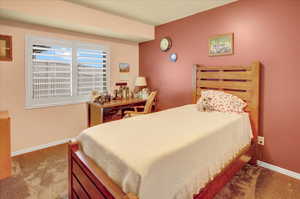 Bedroom with light carpet