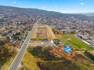 Aerial view of property and surrounding area featuring nearby suburban area and property boundaries highlighted