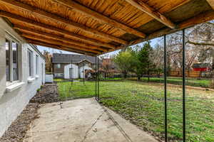 Fenced backyard with a patio and a storage sheds