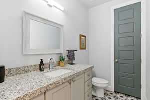 Half bath with vanity and toilet