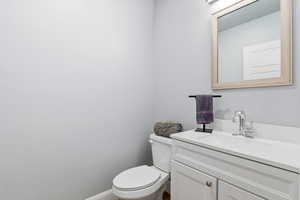 Half bath featuring vanity and toilet