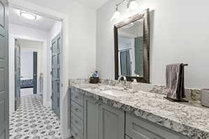 Ensuite bathroom featuring vanity and a shower with shower curtain