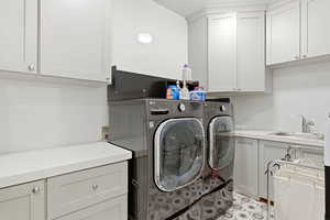 Laundry area featuring cabinet space and independent washer and dryer