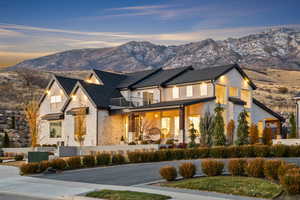 View of front of home with stone siding and a mountain view