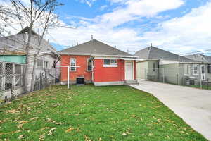 Back of property featuring a fenced backyard, brick siding, and a shingled roof