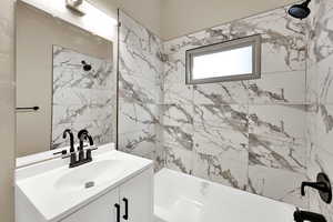 Bathroom with vanity and bathing tub / shower combination