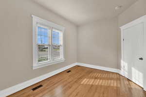 Empty room with baseboards and light wood-style floors