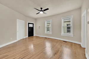 Entrance foyer featuring light wood finished floors and ceiling fan
