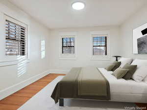 Bedroom featuring light wood-type flooring and baseboards