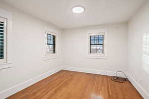 Unfurnished room featuring baseboards and light wood-type flooring