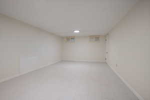 Unfurnished room featuring baseboards and light tile patterned flooring