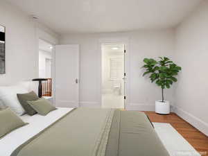 Bedroom featuring connected bathroom and light wood-style flooring
