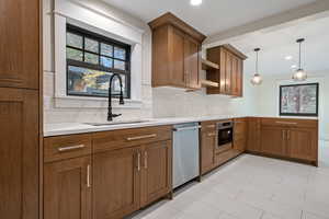 Kitchen featuring decorative backsplash, brown cabinetry, plenty of natural light, pendant lighting, and recessed lighting