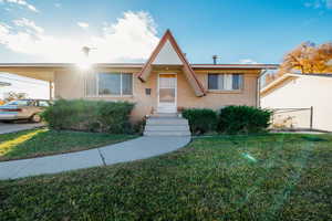 View of front facade with a front lawn and brick siding