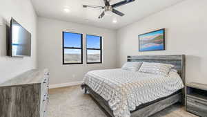 Bedroom featuring light carpet, a ceiling fan, and recessed lighting