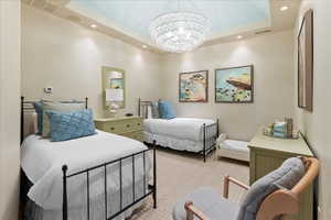 Bedroom with a chandelier, recessed lighting, carpet, and a raised ceiling