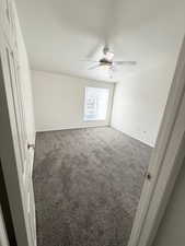 Unfurnished bedroom featuring new carpet and a ceiling fan
