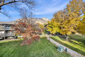 View of property's community featuring a yard and a mountain view