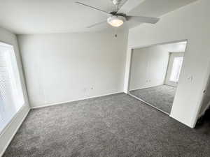 Unfurnished bedroom featuring new carpet, a closet, and a ceiling fan
